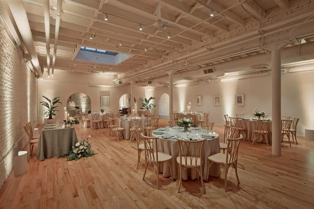 Indoor Los Angeles wedding venue with tound tables, chairs, florals