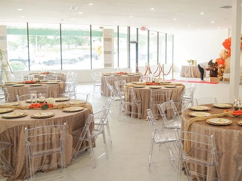 Chicago wedding interior with round tables and orange floral accents