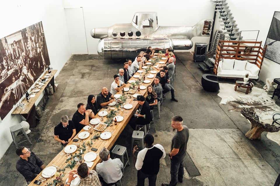 group of people gathered around a beautiful dinner table at a party