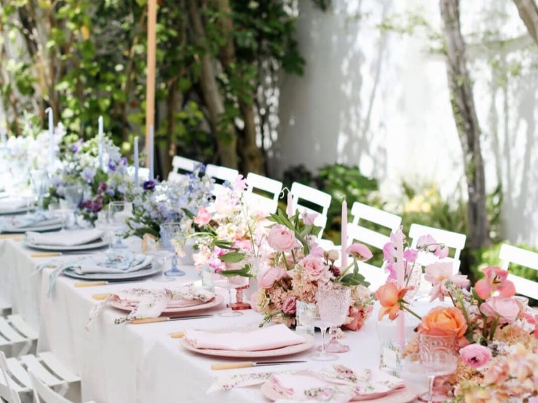 Outdoor Austin wedding with long table and blue and pink florals
