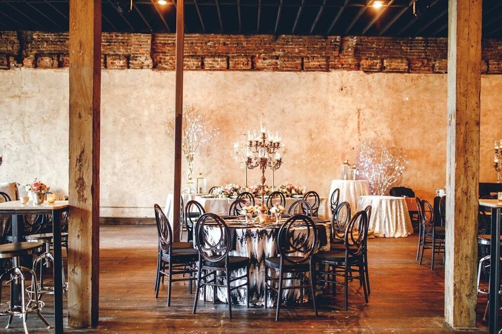 Rustic indoor Tampa wedding venue with round tables and chairs