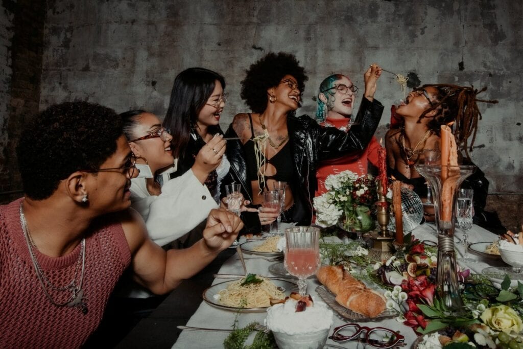 friends laughing at a dinner party table