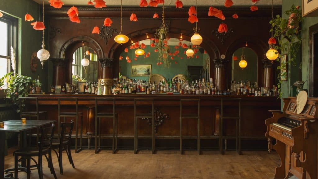 A vintage bar in Denver with wooden accents and a piano