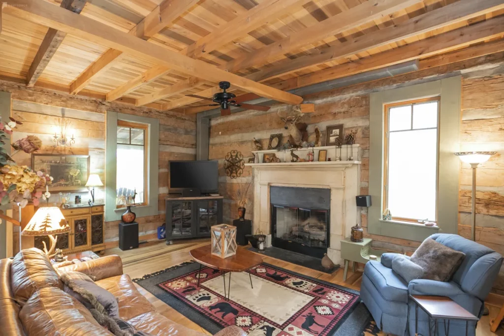 a wood paneled cabin with fireplace