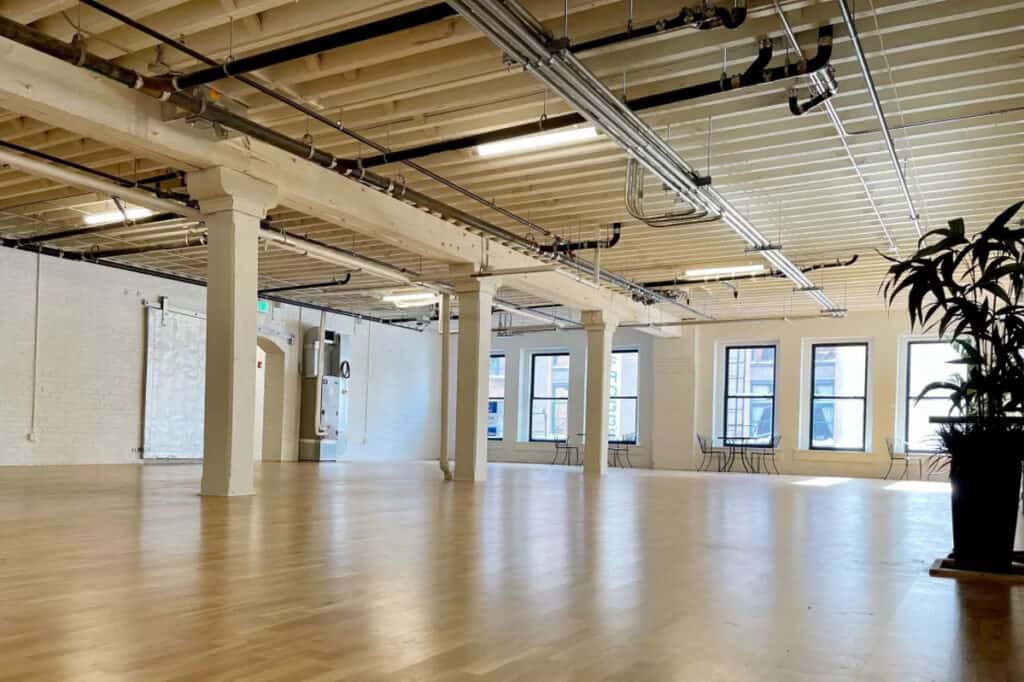 a bright white warehouse with windows and columns