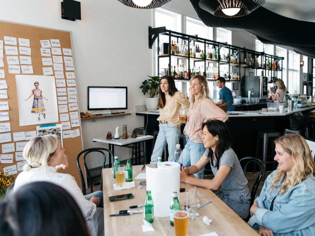 a group of women gathered around a table planning an event