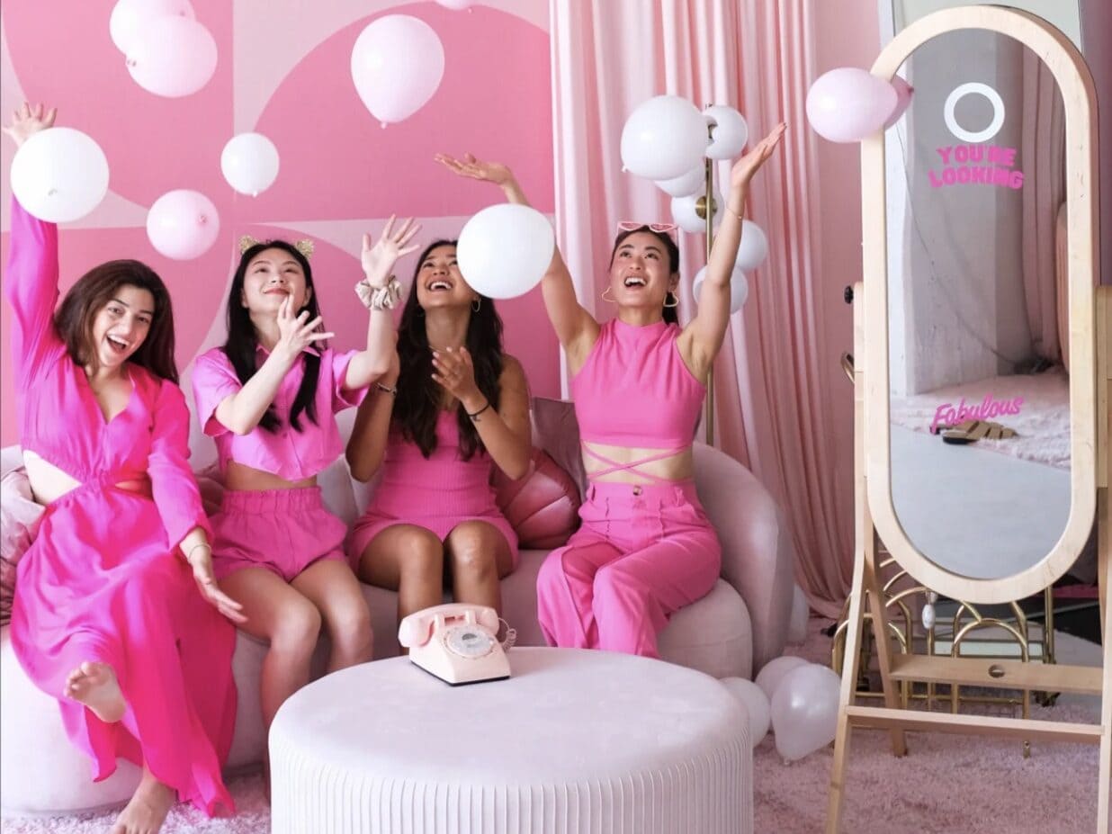 Four friends at a pink-themed Barbie divorce party