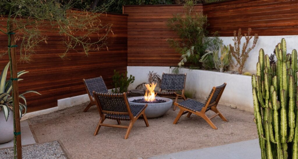 Cozy nook at small backyard wedding with chairs around fire pit