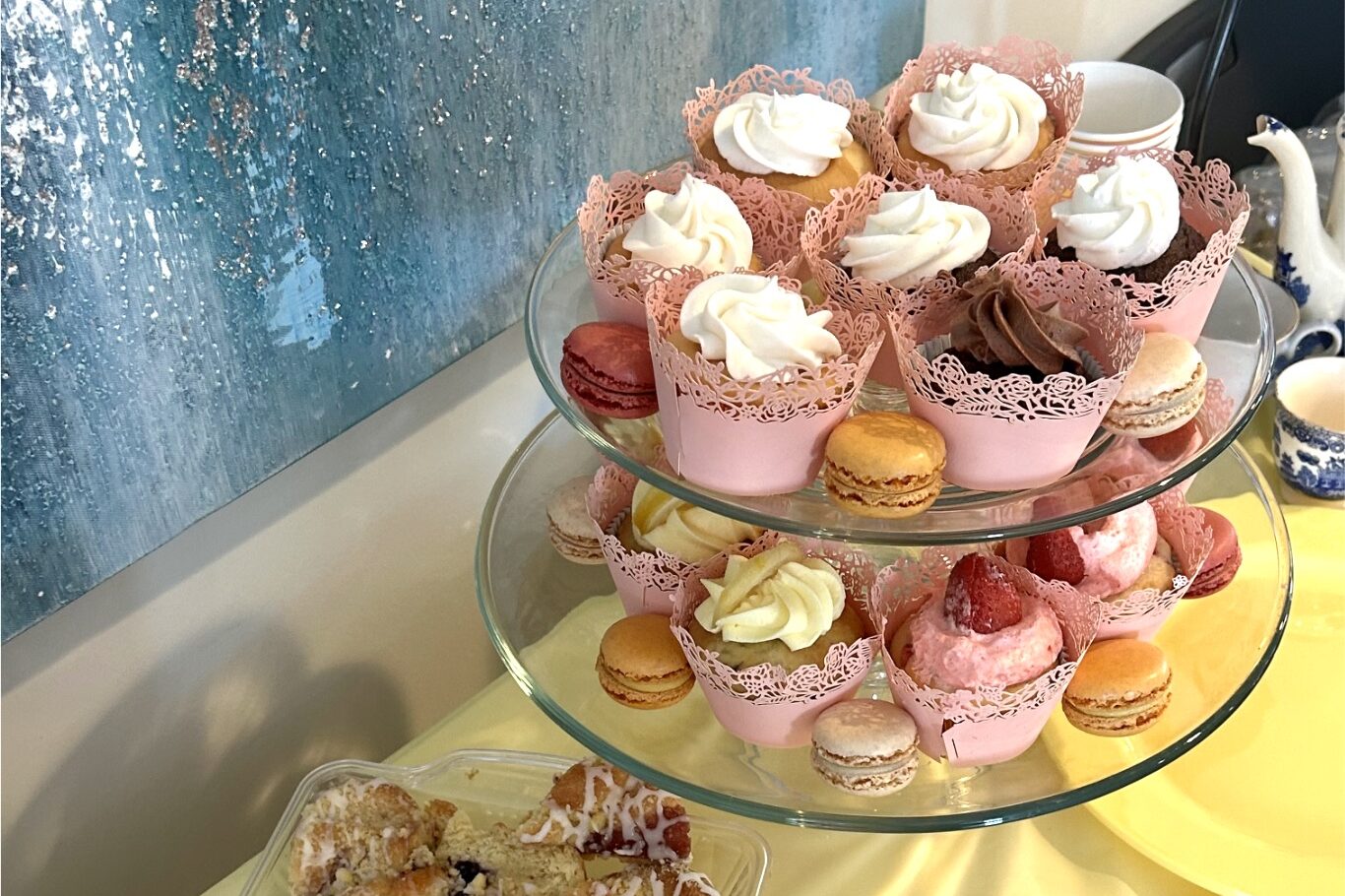 Cupcakes with pink wrapping, macaroons, and strawberries for Galentine's idea at home