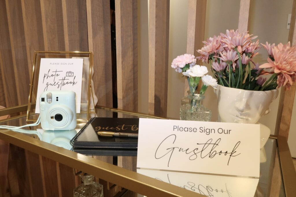 Charlotte wedding planning showing polaroid, guestbook, flowers, and sign