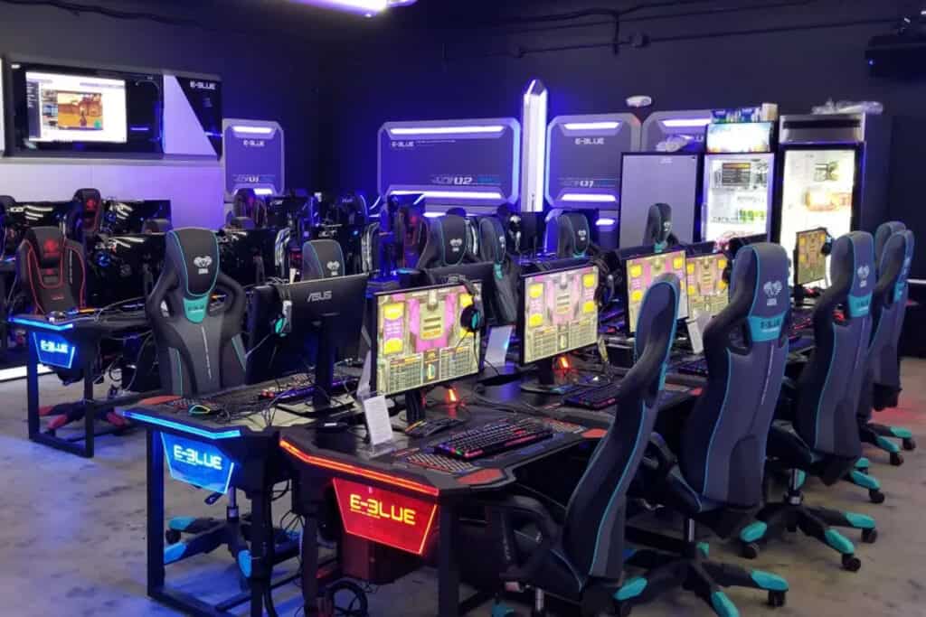 gaming lounge with screens and gaming chairs