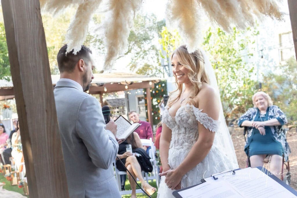 Outdoor Arizona wedding ceremony setup with guests and rustic wooden decor