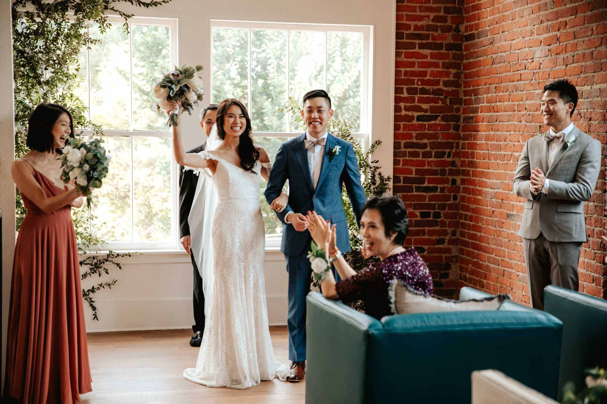 Bride and groom celebrating at a modern brick Baltimore wedding venue