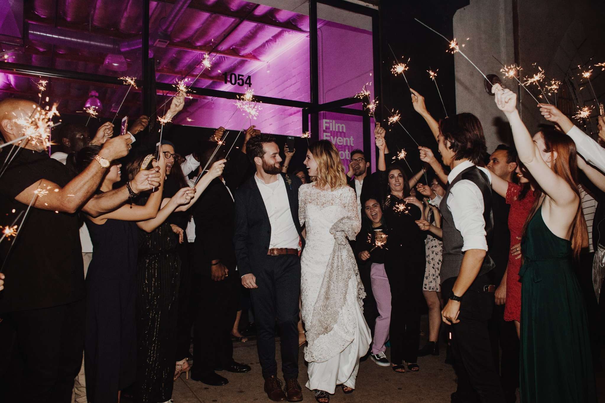 Couple walking through sparkler exit at an industrial Baltimore wedding venue