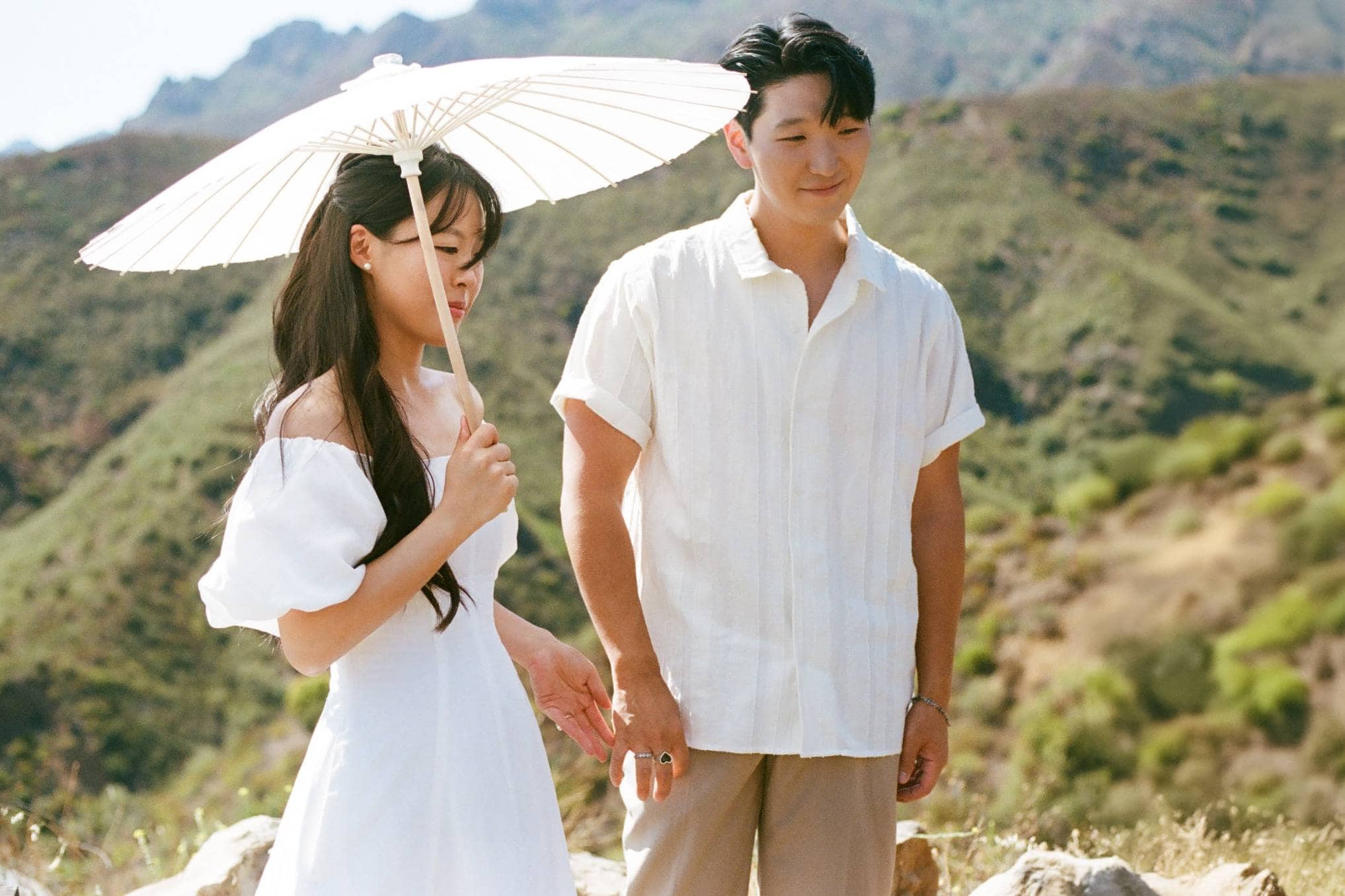 Couple posing for wedding portraits in scenic Boise foothills landscape