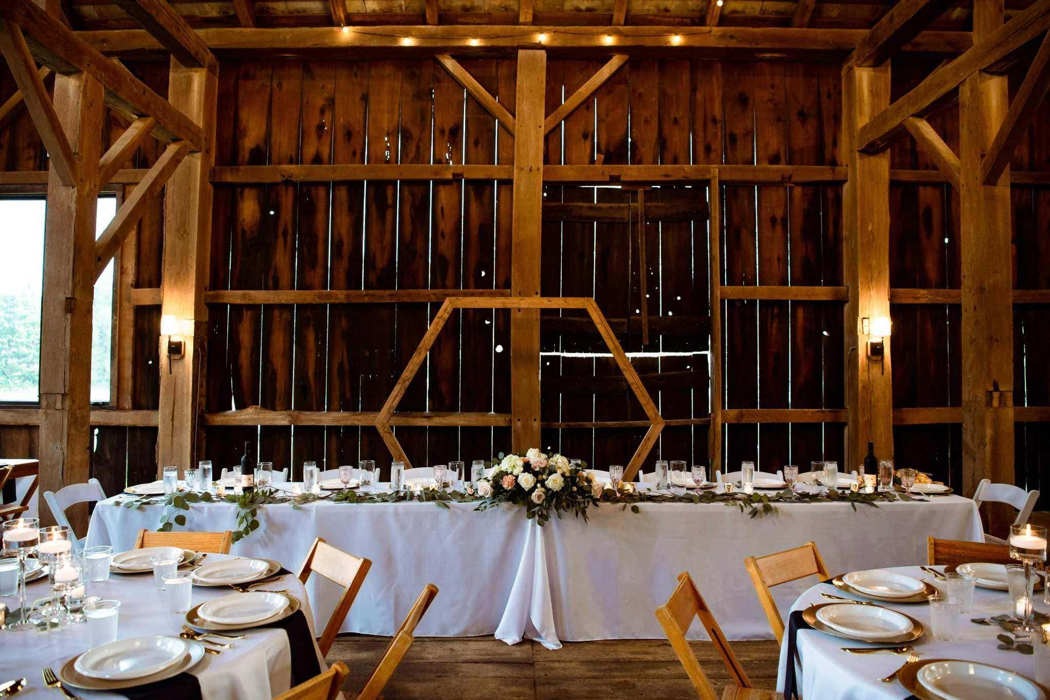 Elegant indoor barn wedding reception dining setup in Boise