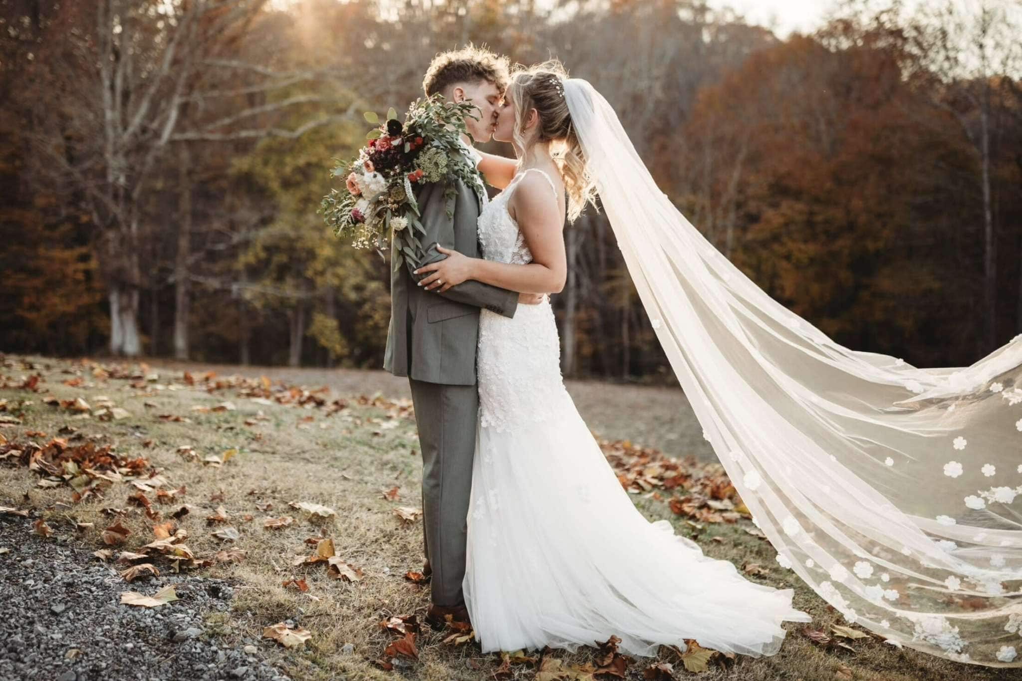 Bride and groom embracing in a colorful Connecticut autumn forest setting