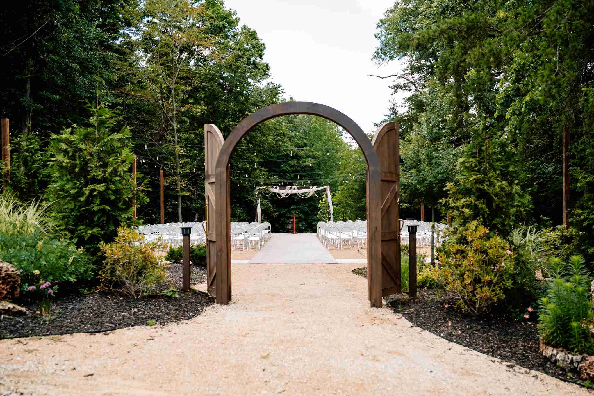 Wooden archway framing an outdoor wedding ceremony setup in Connecticut nature