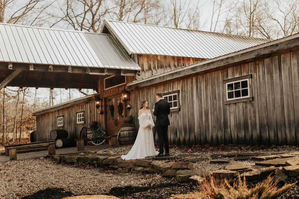 Bride and groom outside rustic Des Moines barn wedding venue