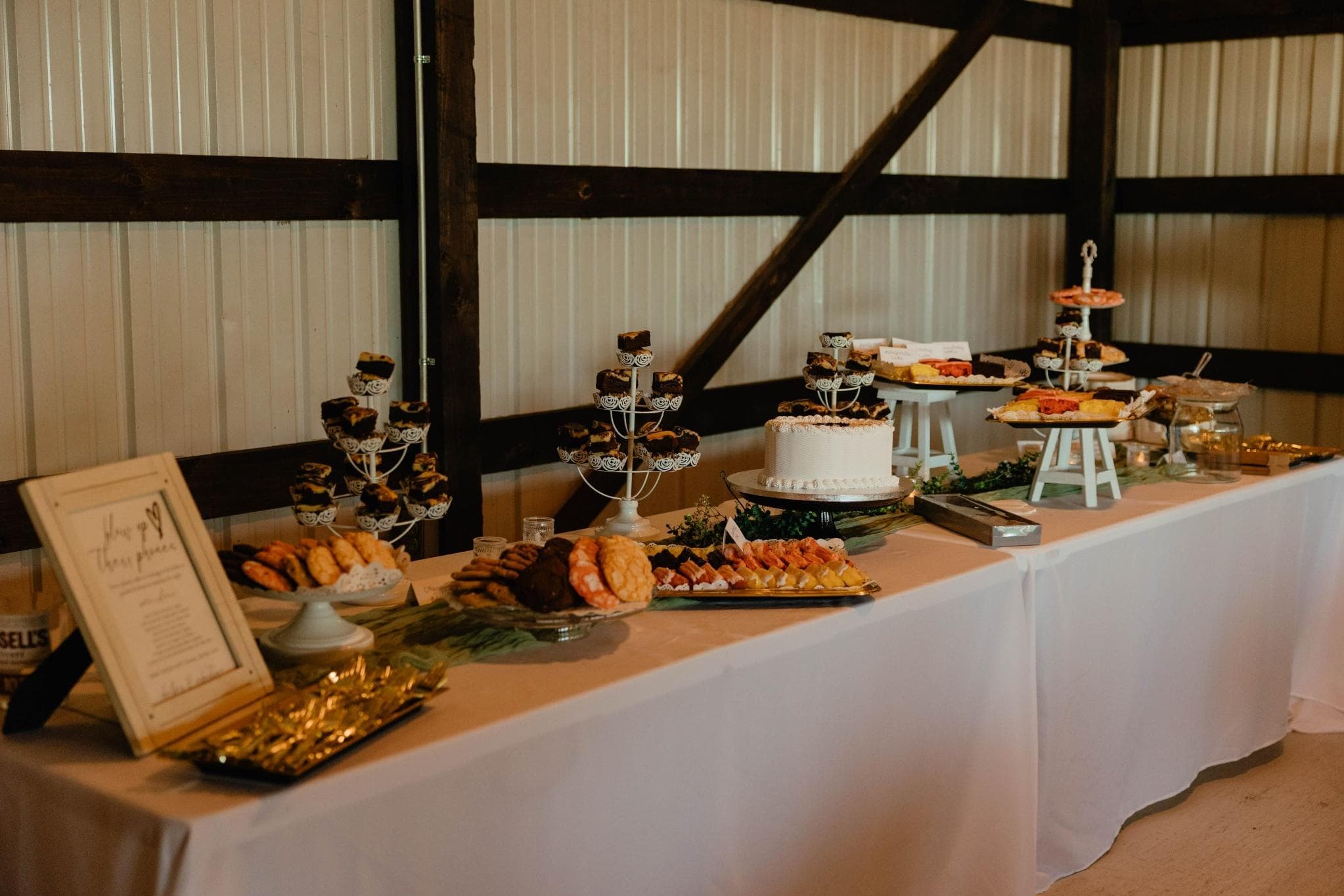 Rustic Des Moines wedding reception dessert table with tiered cake