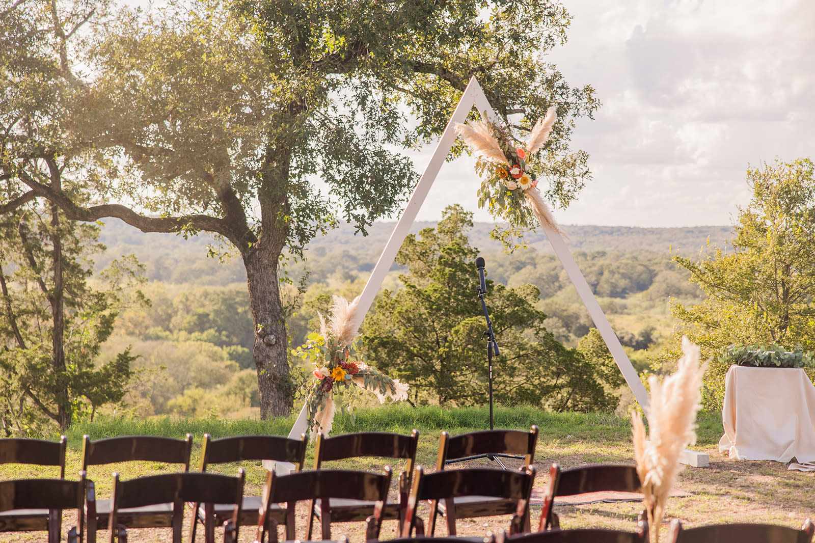 Outdoor wedding ceremony setup with floral arch in Fort Worth nature