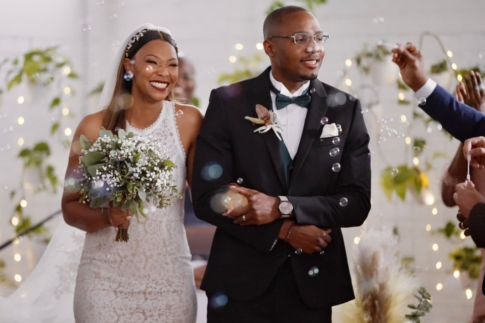 Joyful bride and groom walking through sparkling Fort Worth wedding venue