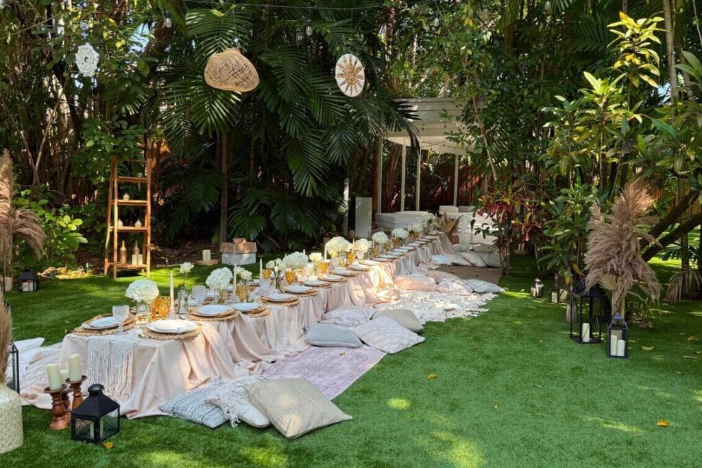 Hawaii wedding in a lush outdoor space with floor-level long table and place settings