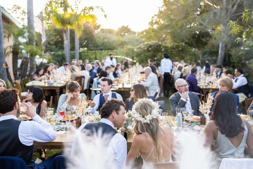 Outdoor wedding planned in Hawaii with wedding guests seated at tables