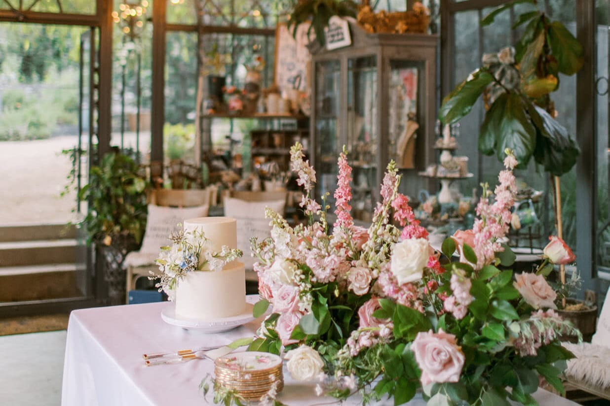 Greenhouse wedding reception decor and cake styled by Wedding Planners in Lexington