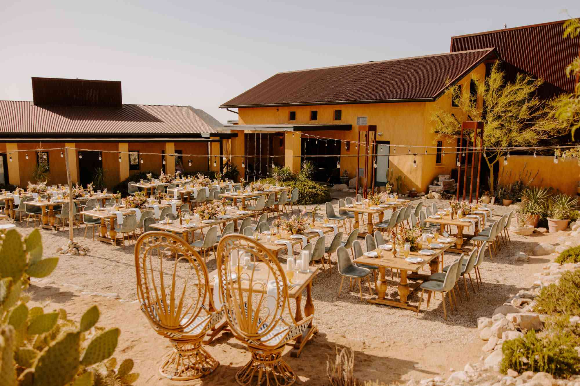 Rustic outdoor dining setup with string lights for New Mexico wedding reception