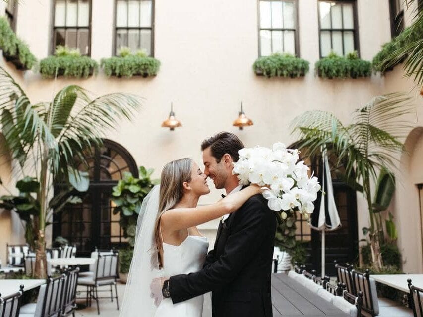 Couple embracing at New Orleans wedding venue outdoors