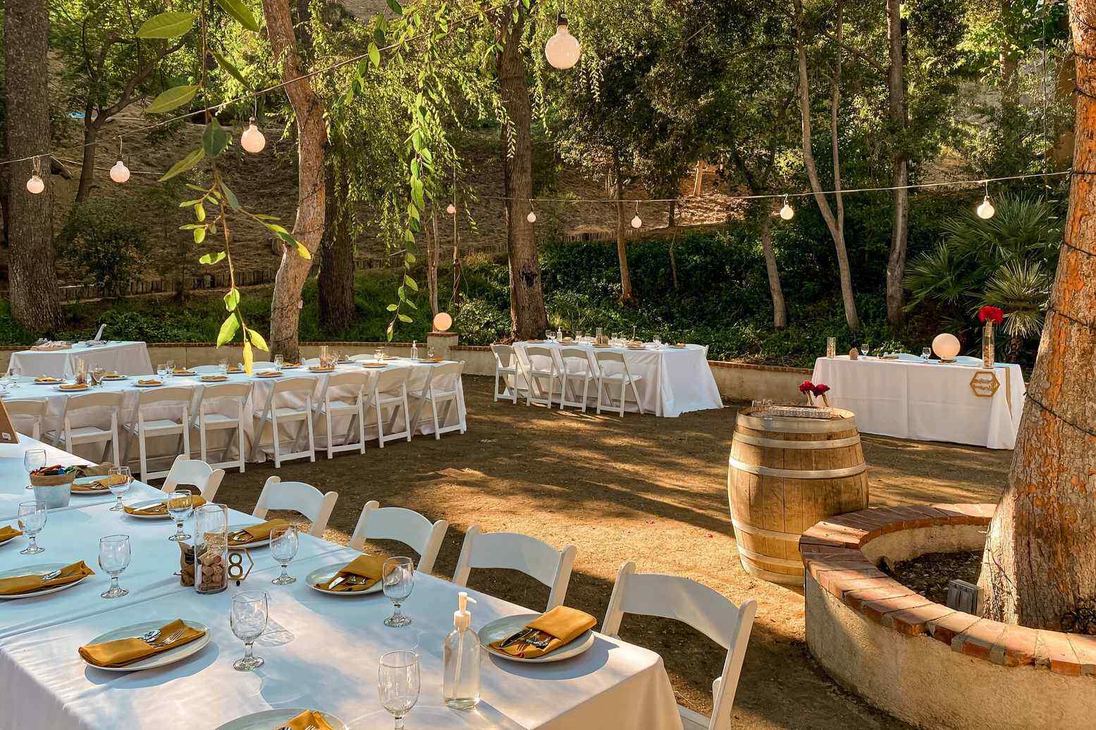 Outdoor Omaha wedding reception setup with string lights and barrels