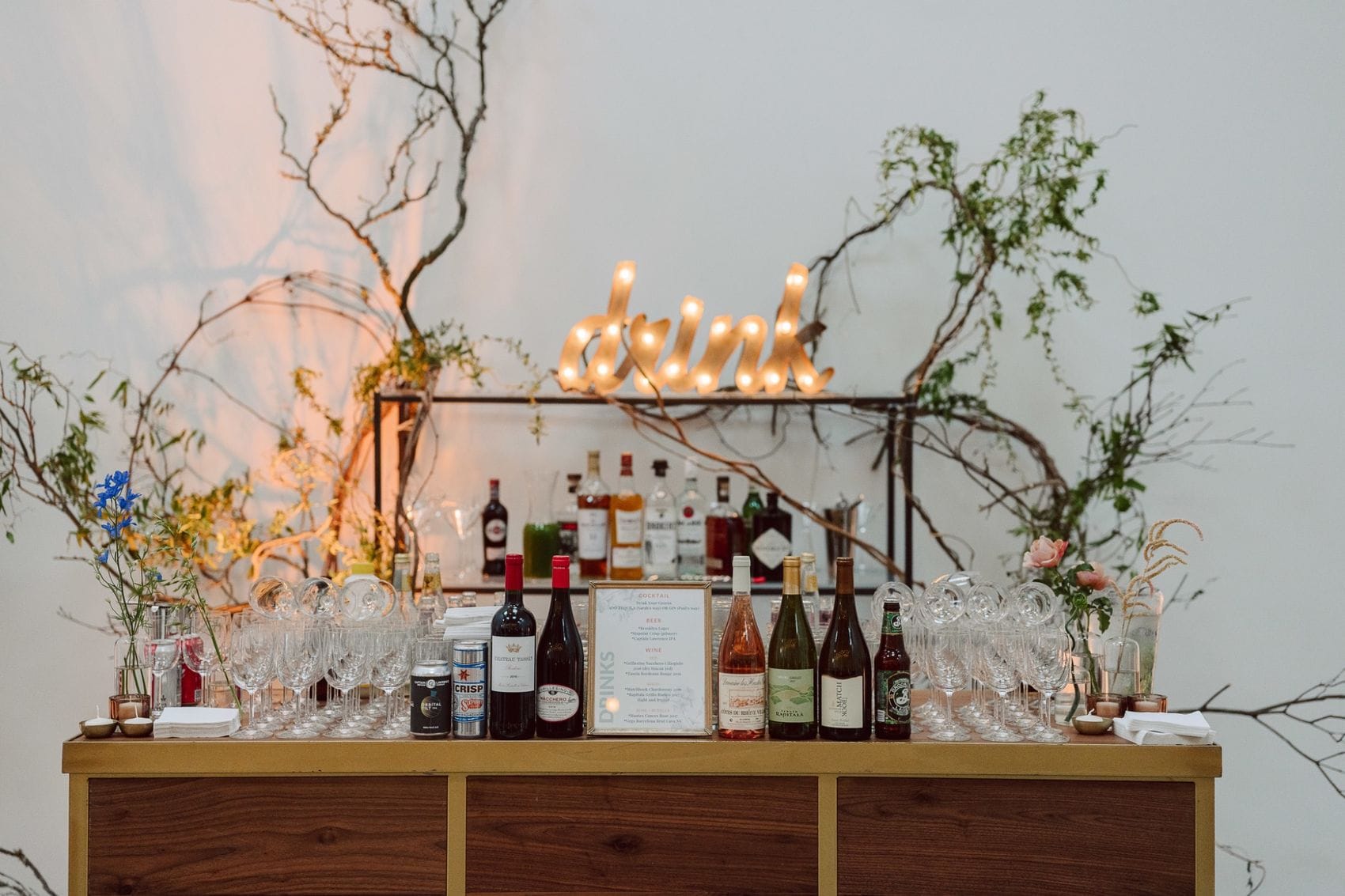 Stylish bar setup with neon sign and floral decor for Phoenix events