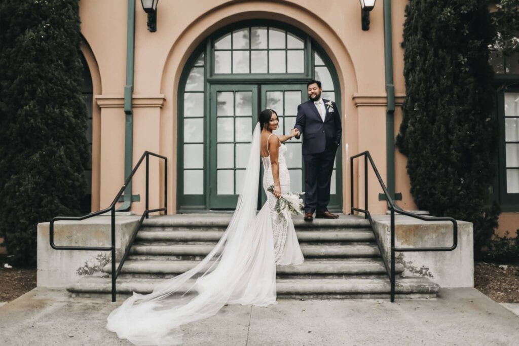 Couple posing on steps of a San Antonio TX wedding venue