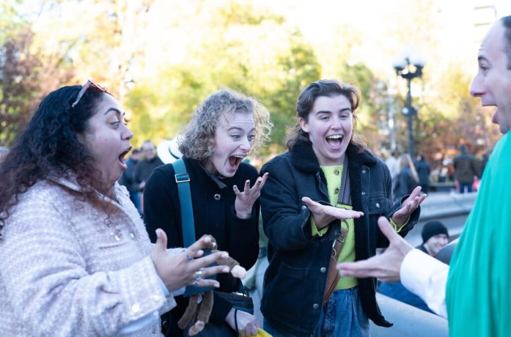 A group of people participate in Accomplice the Village, a low-tech comedic walking tour in NYC.