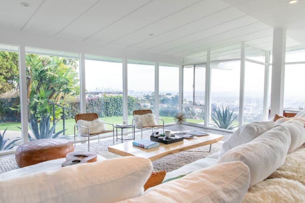 window-filled house atop a hill