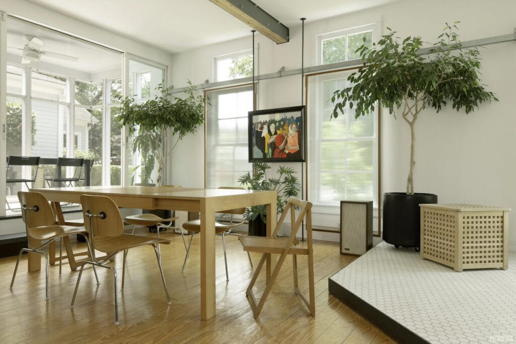 Light wood accents and greenery decorate a sun-drenched small meetings space