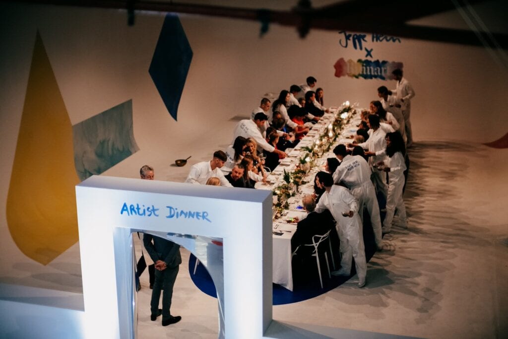 Guests are served by staff at a formal dinner