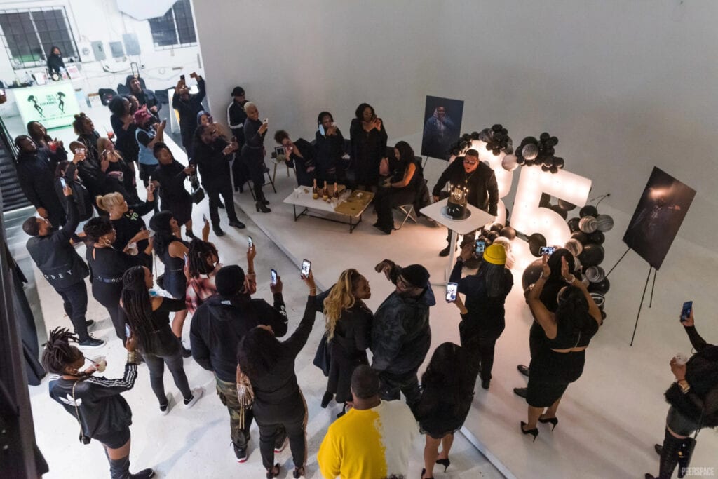 Partygoers gather as guest of honor blows out birthday candles
