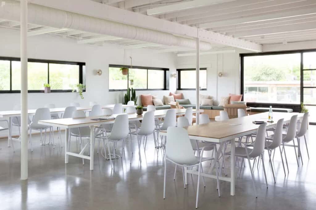 an all-white creative space with tables and chairs in austin