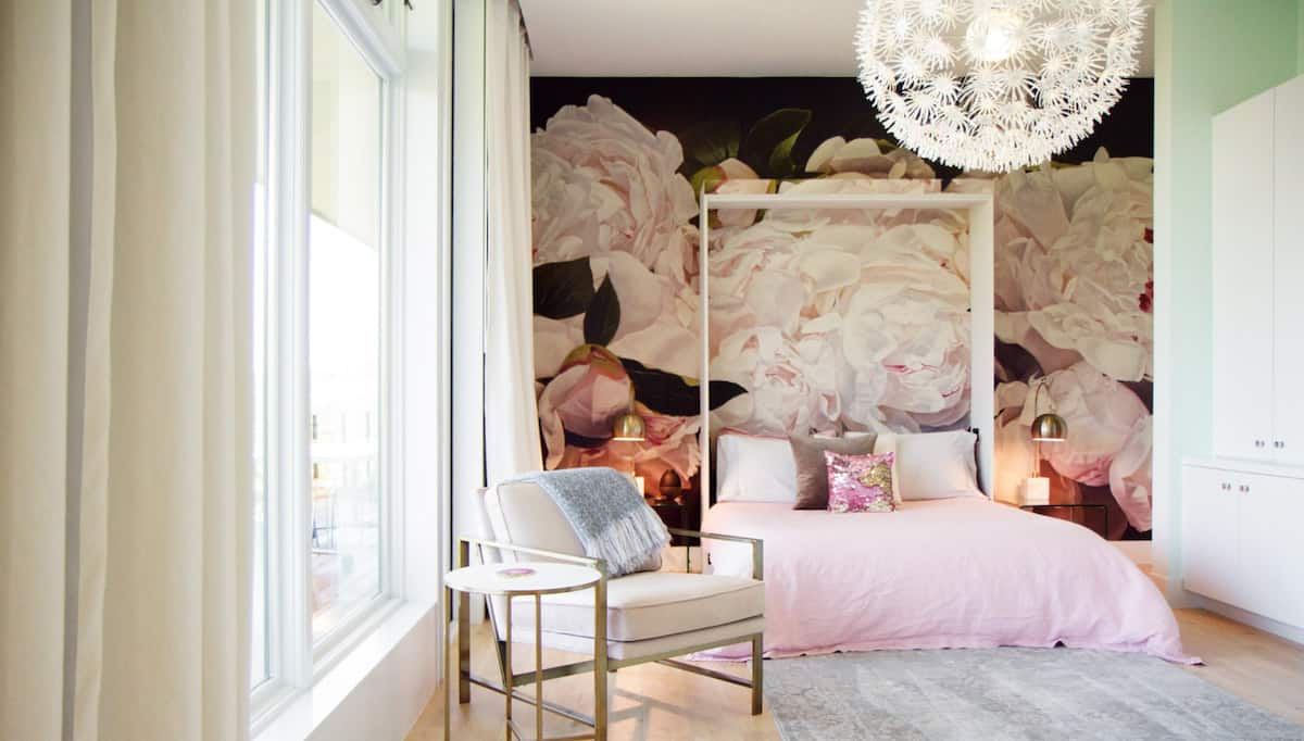 Luxurious Austin bedroom photo shoot location with floral mural, chandelier, and floor to ceiling windows