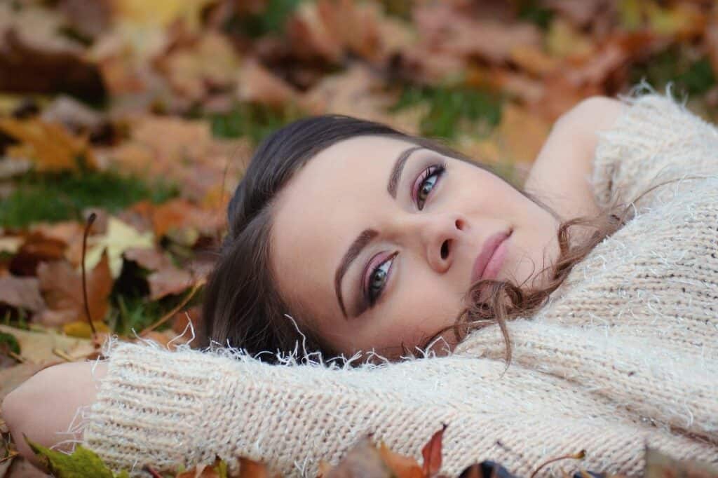 girl lying on autumn leaves