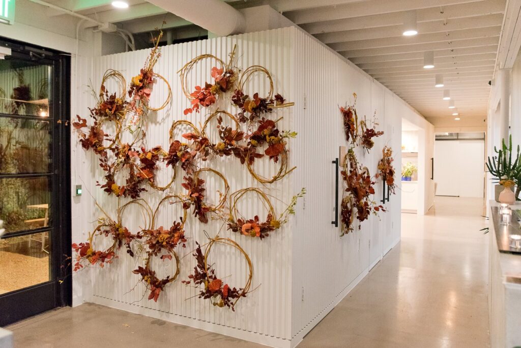 autumn wreaths hung on a white wall