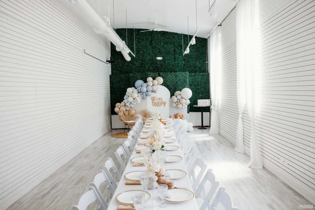 Simple baby shower gathering in pristine white space