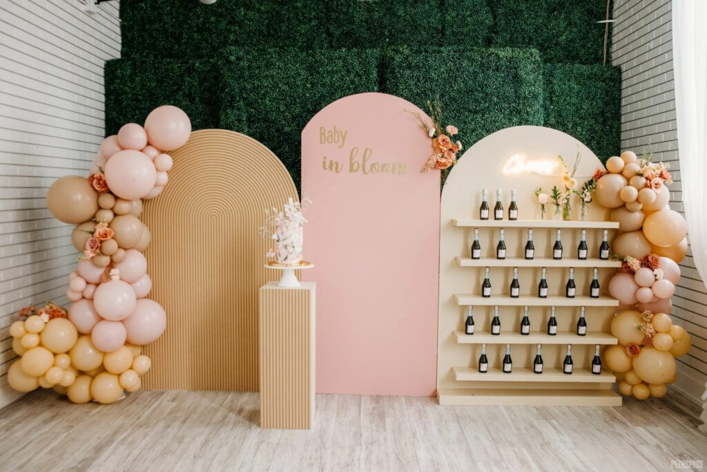 baby shower sprinkle decor with cake, balloons and champagne
