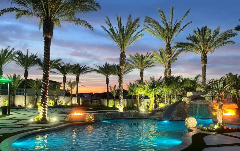 Palm trees surround pool at dusk in San Antonio