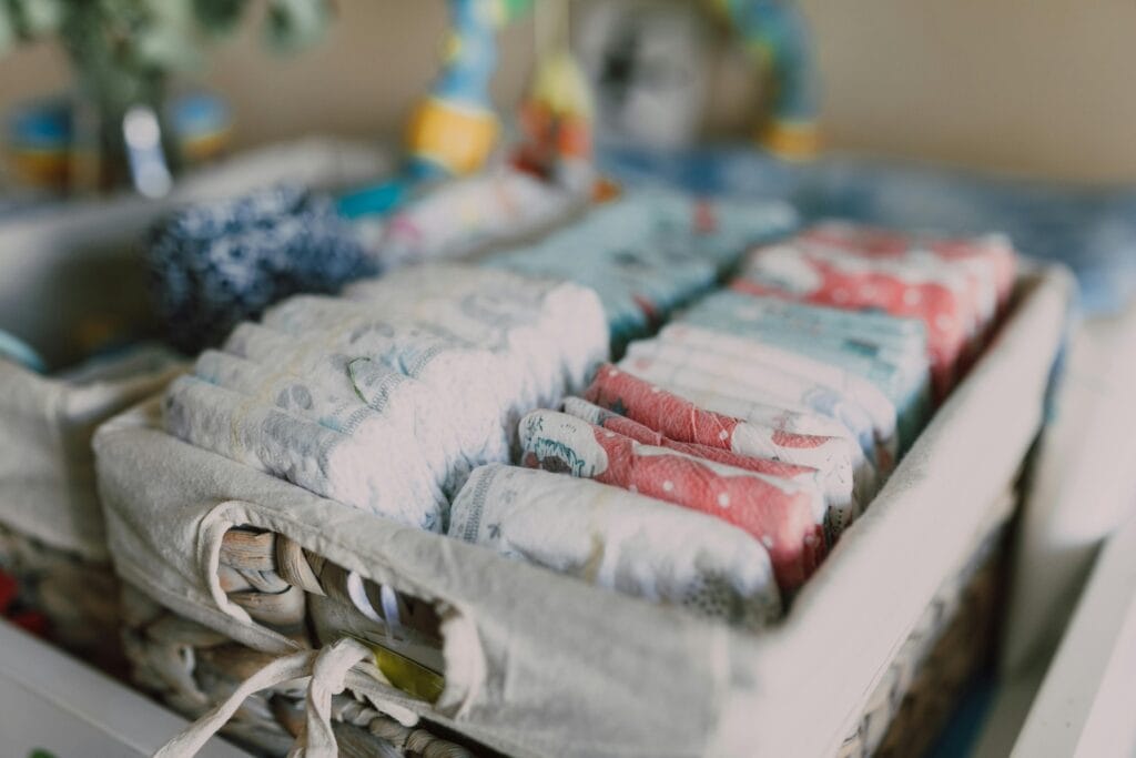 Baby diapers are perfectly organized in a small basket