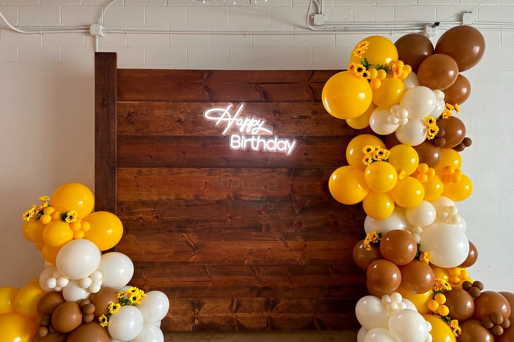Neon Happy Birthday sign with balloon garland for Houston birthday party decor