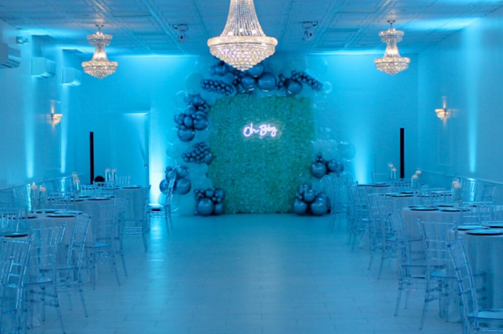 a blue-lit venue dressed for a baby shower
