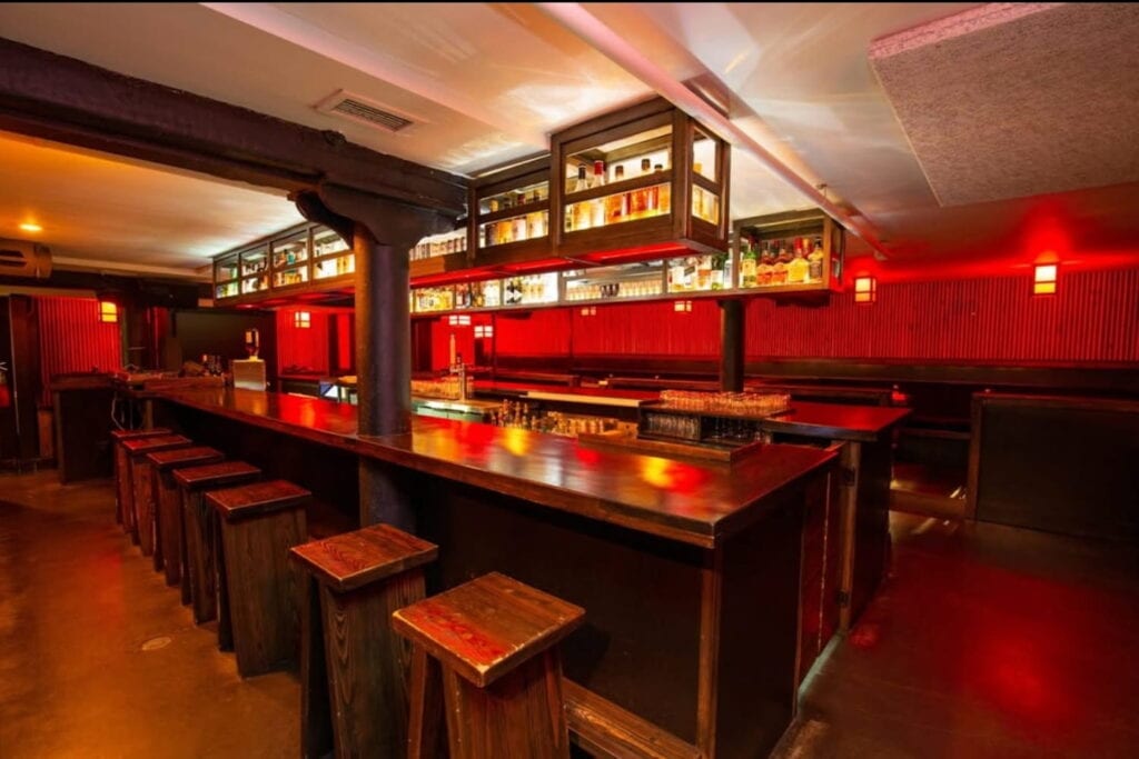 Interior shot of intimate, underground basement bar called Booze Box in Chicago